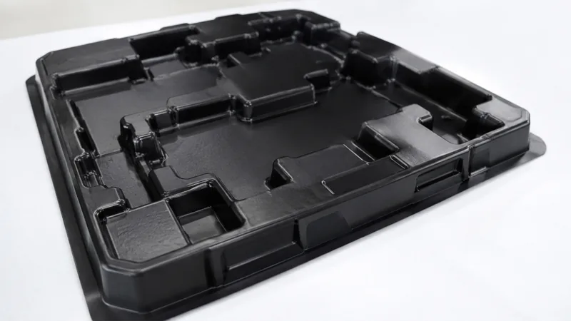 Black heavy gauge thermoformed packaging tray with multiple cavities