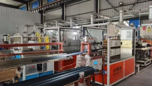 Black plastic profile emerging from extrusion line haul-off mechanism
